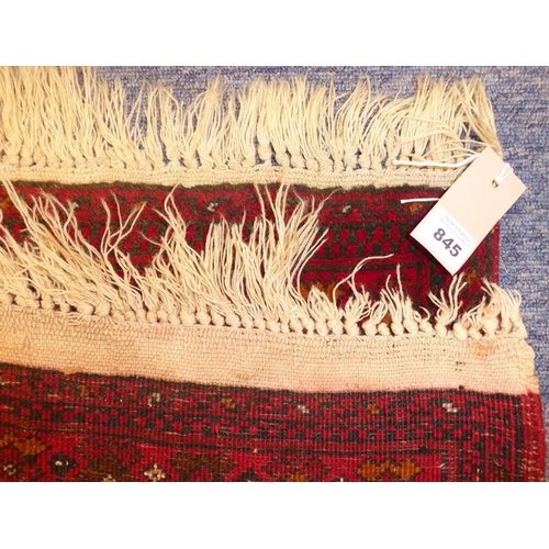 845 - A small Afghan rug with red ground (96cm x 58cm)