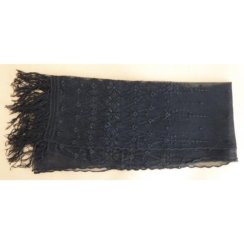 847 - A circa 1930s black-embroidered tulle stole in good condition; floral design and tassels to the ends... 