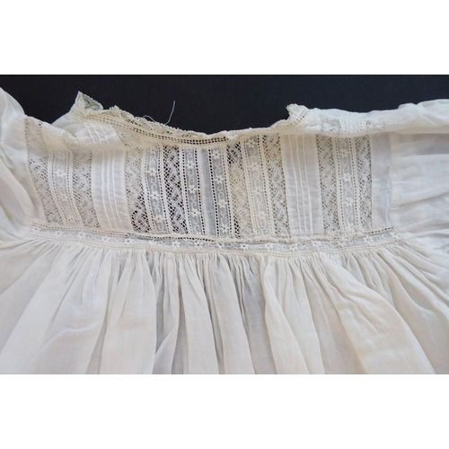 853 - A 1930s Happy Days baby's cotton nightgown; ivory cotton lawn with white work details and applied la... 