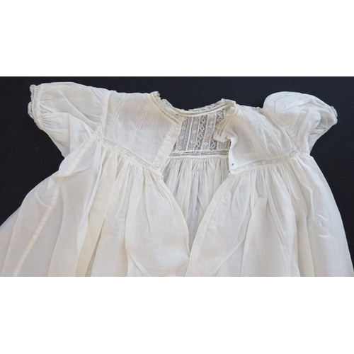 853 - A 1930s Happy Days baby's cotton nightgown; ivory cotton lawn with white work details and applied la... 