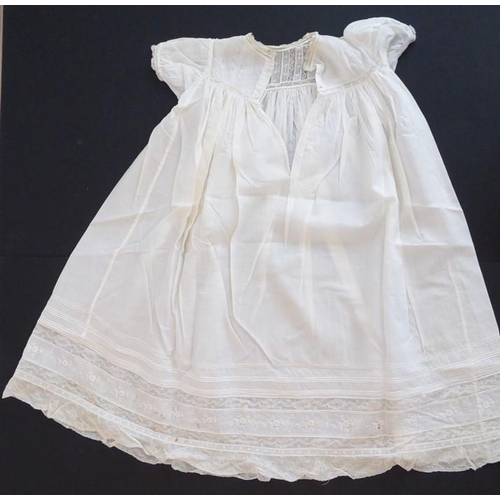 853 - A 1930s Happy Days baby's cotton nightgown; ivory cotton lawn with white work details and applied la... 