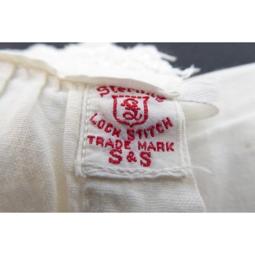 855 - A circa 1950s baby's nightgown; ivory-coloured cotton, gathered front with sash ties, long sleeves a... 