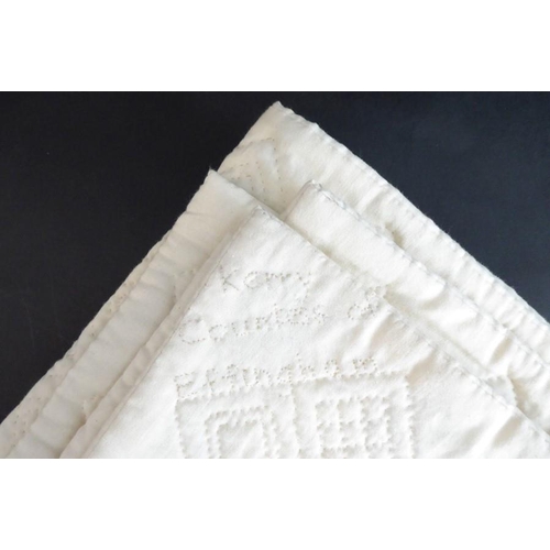 862 - A hand-stitched, double sided, all-white Durham quilt; central four-point motif radiating with leaf ... 