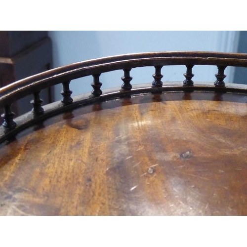 863 - A small George III circular mahogany urn style table; the galleried balustraded top above turned ste... 