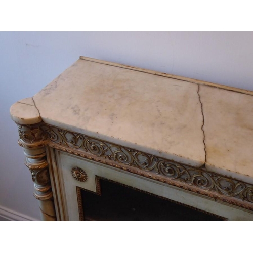 866 - A 19th century marble topped pier cabinet; two glazed doors below a gilt frieze decorated with scrol... 