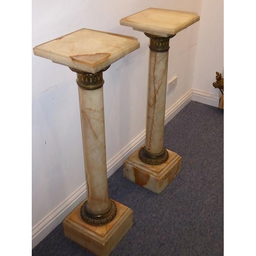 884 - A pair of 19th century veined-marble and gilt-metal mounted pedestal stands of columnar form; each s... 