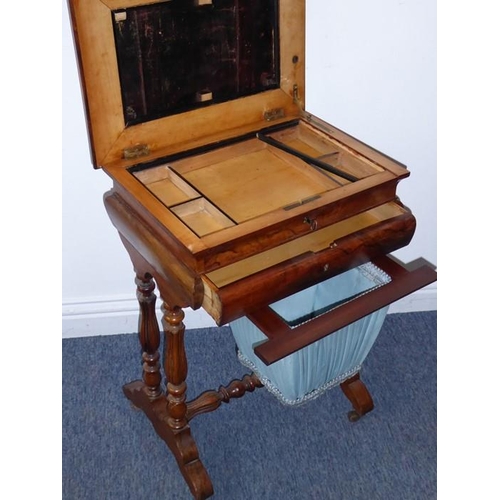 911 - A mid-19th century figured walnut work table; the moulded hinge top opening to reveal compartmentali... 