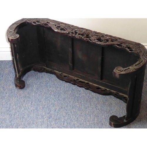 912 - A late 19th/early 20th century Chinese hardwood low table; the fielded panelled top rebating into si... 