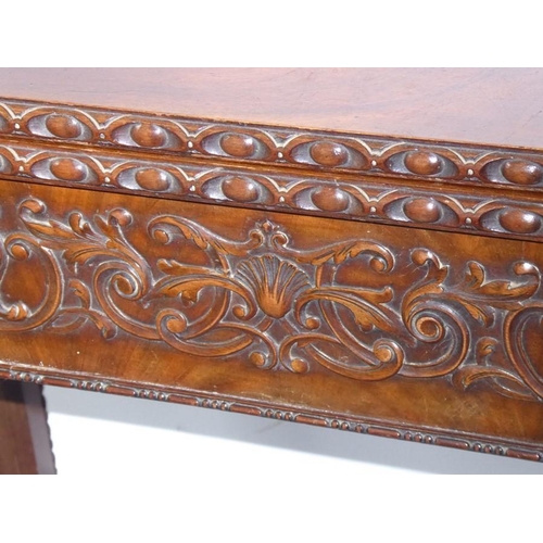 915 - A mid 18th century mahogany fold over top card table; the figured top above the two edges opening to... 