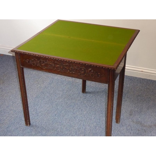 915 - A mid 18th century mahogany fold over top card table; the figured top above the two edges opening to... 