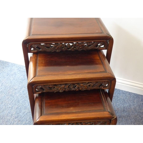 917 - A nest of four early 20th century Chinese carved hardwood occasional tables, the pierced friezes car... 