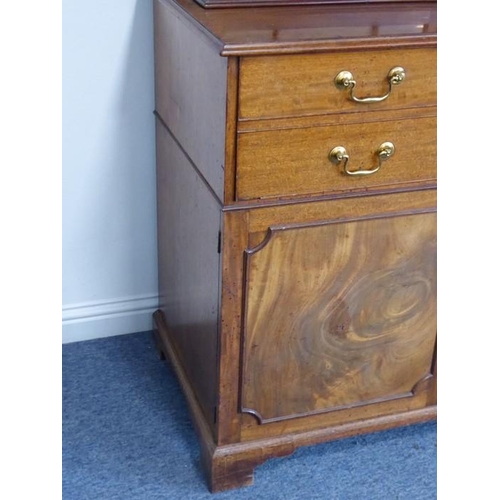 928 - An 18th century mahogany secretaire bookcase; the broken swan-neck pediment pierced in open fretwork... 