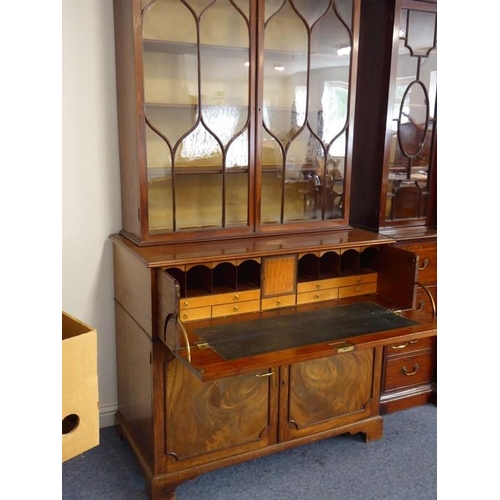 928 - An 18th century mahogany secretaire bookcase; the broken swan-neck pediment pierced in open fretwork... 