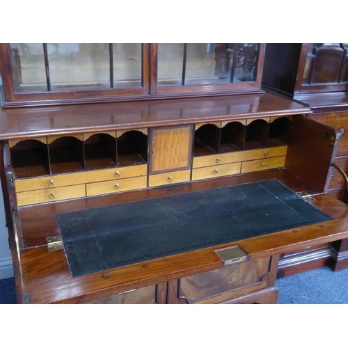 928 - An 18th century mahogany secretaire bookcase; the broken swan-neck pediment pierced in open fretwork... 