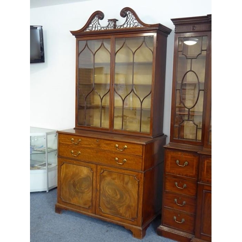 928 - An 18th century mahogany secretaire bookcase; the broken swan-neck pediment pierced in open fretwork... 