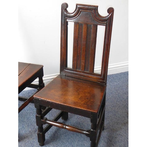 933 - A pair of late 17th/early 18th century oak side chairs; each with shaped crest rail, vertical splats... 