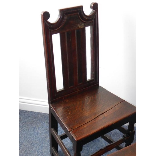 933 - A pair of late 17th/early 18th century oak side chairs; each with shaped crest rail, vertical splats... 