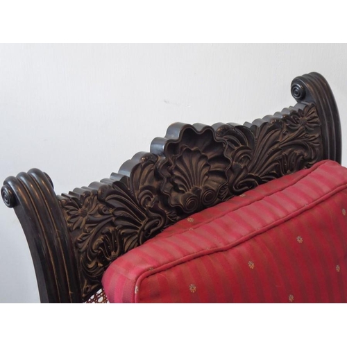 942 - A good mid-19th century Anglo-Indian carved ebony Planter's-style chair; the back and seat squab cus... 