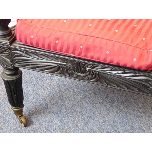 942 - A good mid-19th century Anglo-Indian carved ebony Planter's-style chair; the back and seat squab cus... 