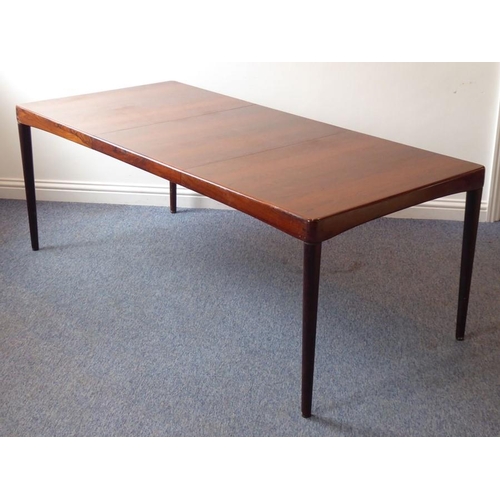 945 - A 20th century extending rosewood dining table by 'Bramin' (Denmark); with central extension leaf st... 