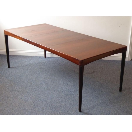 945 - A 20th century extending rosewood dining table by 'Bramin' (Denmark); with central extension leaf st... 