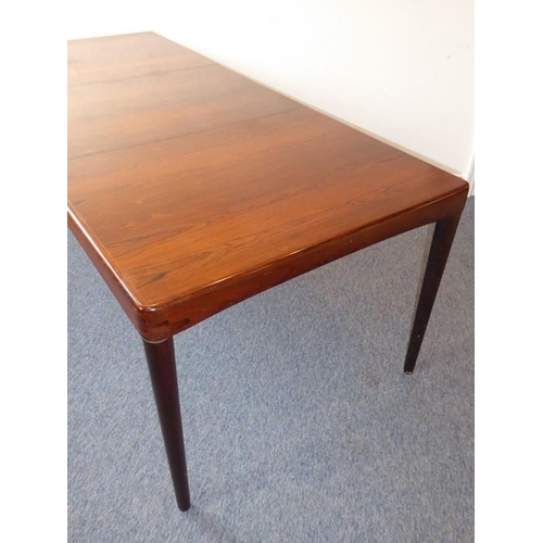 945 - A 20th century extending rosewood dining table by 'Bramin' (Denmark); with central extension leaf st... 