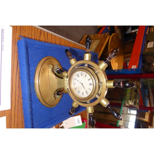 402 - A 19th century novelty brass mantel clock modelled as a ship's wheel with turned varying coloured ag... 