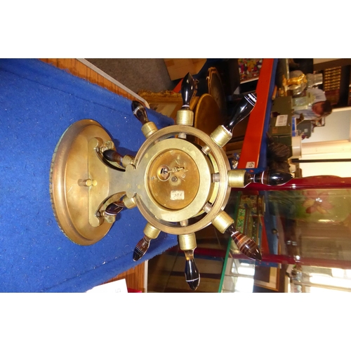 402 - A 19th century novelty brass mantel clock modelled as a ship's wheel with turned varying coloured ag... 