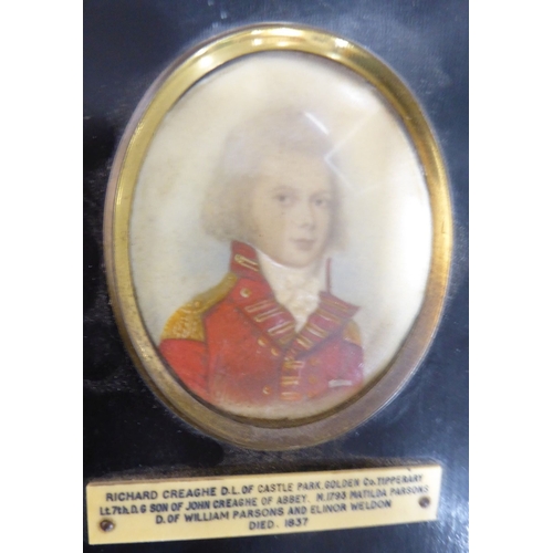 511 - A late 18th/early 19th century shoulder-length portrait miniature study of a young boy in red milita... 