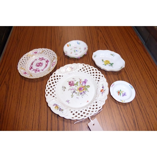 16 - A porcelain group of mostly Meissen; a reticulated dish hand-decorated with a floral spray, one othe... 