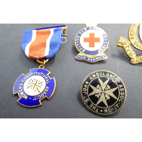 742 - A selection of enamel Red Cross and other awards and badges, one marked 'Zoe Beaver'; together with ... 