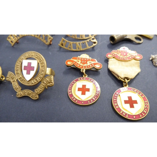 742 - A selection of enamel Red Cross and other awards and badges, one marked 'Zoe Beaver'; together with ... 