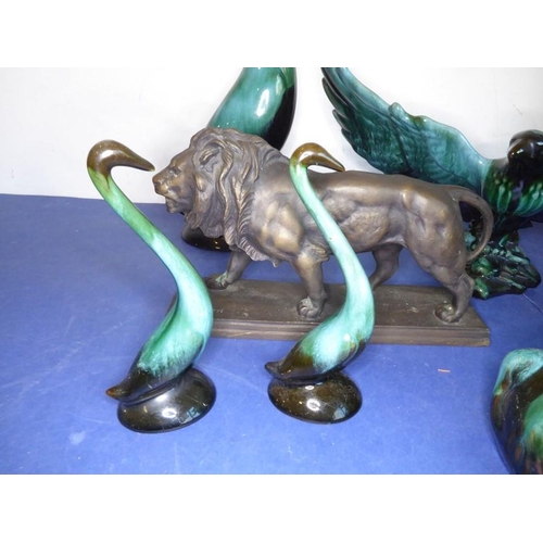 12 - Eight green glazed ceramic animals including dogs, a cat and an open-winged bird (the tallest 46.5cm... 