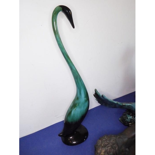 12 - Eight green glazed ceramic animals including dogs, a cat and an open-winged bird (the tallest 46.5cm... 