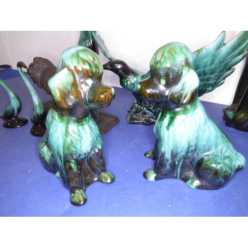 12 - Eight green glazed ceramic animals including dogs, a cat and an open-winged bird (the tallest 46.5cm... 