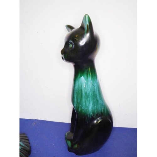 12 - Eight green glazed ceramic animals including dogs, a cat and an open-winged bird (the tallest 46.5cm... 