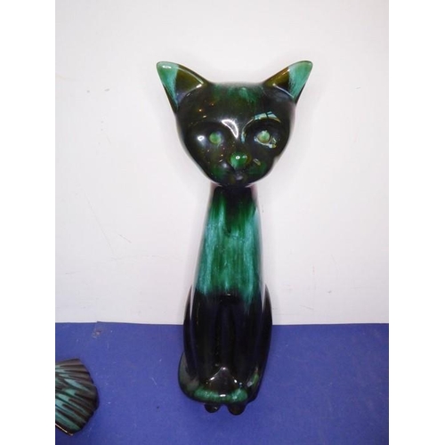 12 - Eight green glazed ceramic animals including dogs, a cat and an open-winged bird (the tallest 46.5cm... 