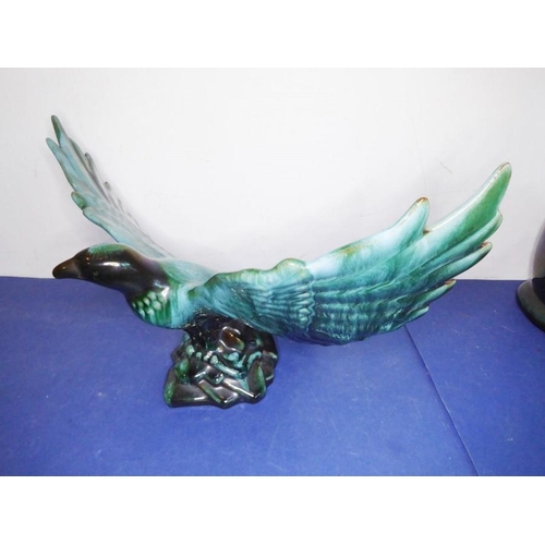 12 - Eight green glazed ceramic animals including dogs, a cat and an open-winged bird (the tallest 46.5cm... 