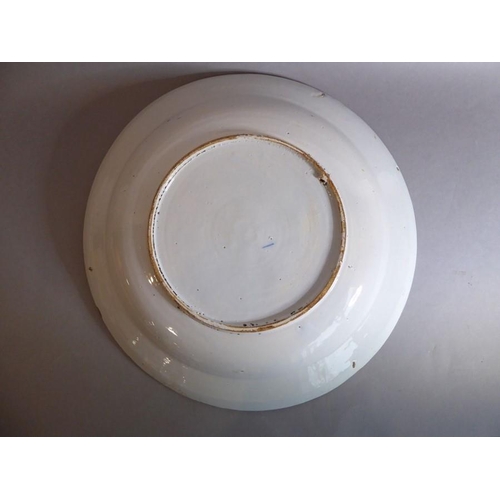2 - A large 18th century circular tin-glazed earthenware dish; hand painted in blue and white