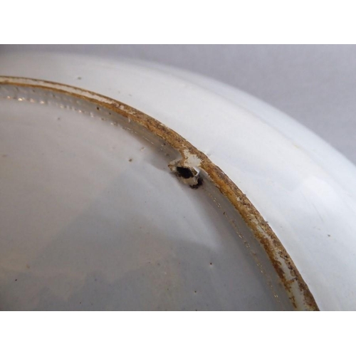 2 - A large 18th century circular tin-glazed earthenware dish; hand painted in blue and white