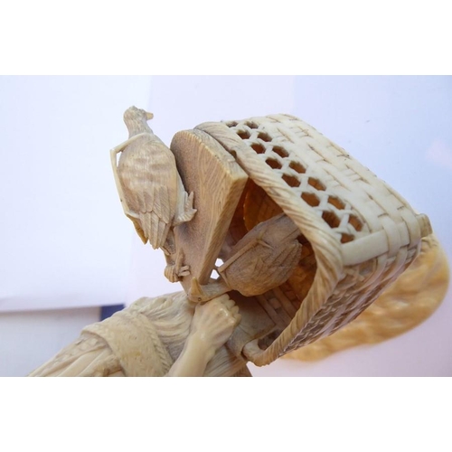240 - A very finely carved Japanese Meiji period ivory carving depicting a male figure holding a woven wic... 