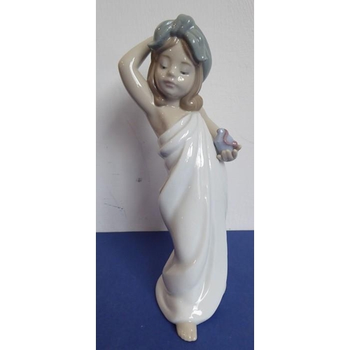 28 - Three Lladro and two Nao porcelain figures; the Nao figures of a girl in first communion dress (23cm... 