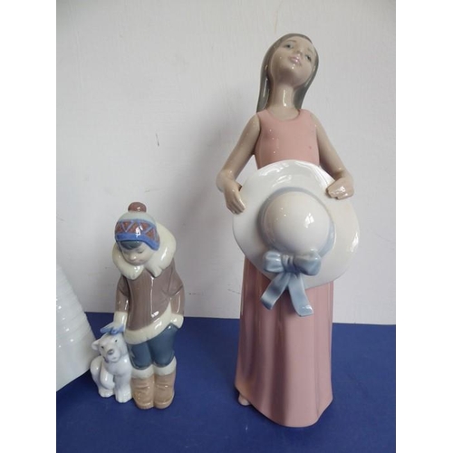 28 - Three Lladro and two Nao porcelain figures; the Nao figures of a girl in first communion dress (23cm... 