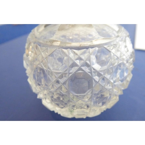 40 - A pair of early 20th century spherical cut-glass silver-mounted scents; the hinged lids decorated in... 