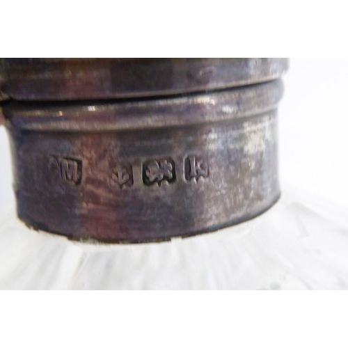 40 - A pair of early 20th century spherical cut-glass silver-mounted scents; the hinged lids decorated in... 