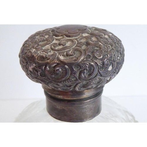 40 - A pair of early 20th century spherical cut-glass silver-mounted scents; the hinged lids decorated in... 