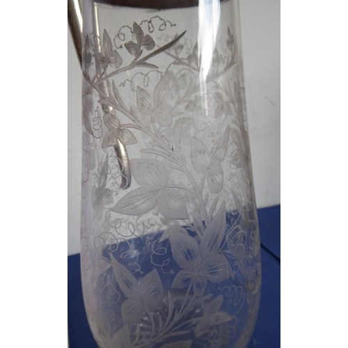 44 - A late 19th century baluster-shaped glass claret jug with silver-plated mounts; the main body very f... 