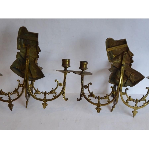 55 - Two late 19th/early 20th century three-light brass wall appliques; each headed with shoulder length ... 