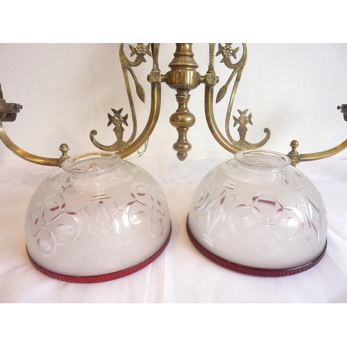 56 - A large and ornate 19th century two-branch gasolier with etched-glass shades having cranberry edges ... 