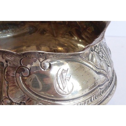 144 - Three pieces of hallmarked silver: a 19th century cauldron-shaped sugar bowl decorated in repoussé s... 